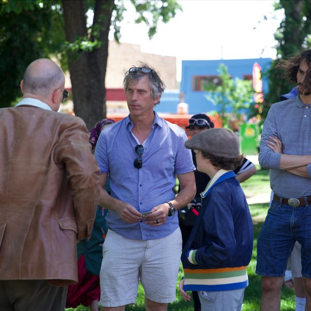 David giving notes in the park to the young lead and cast